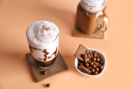 Tasty frappe coffee and sweets on tableの写真素材