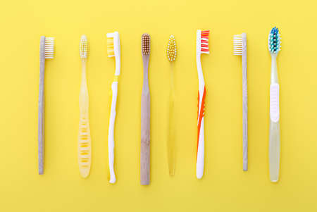 Different tooth brushes on color backgroundの写真素材