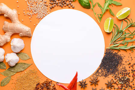 Empty paper sheet with different spices on color backgroundの写真素材