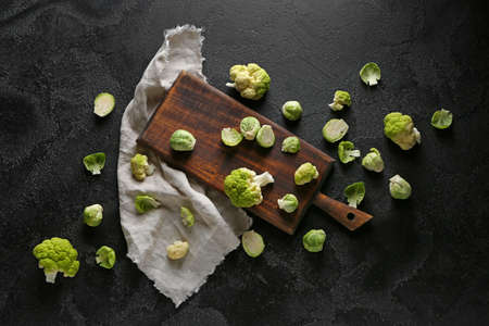 Board with different fresh cabbage on dark backgroundの写真素材