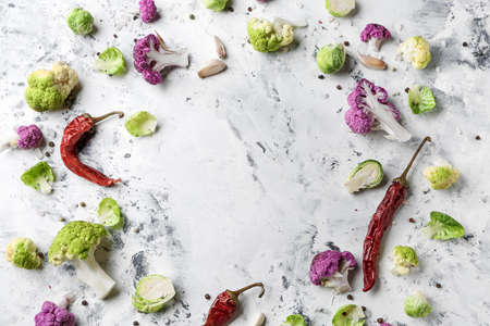 Frame made of chili pepper with different cabbage on light background