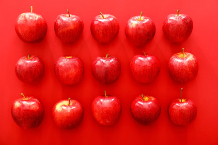 Ripe apples on color backgroundの写真素材