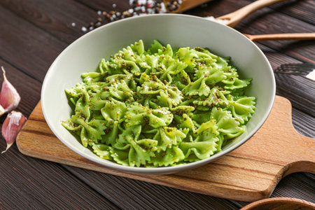 Plate with tasty boiled pasta on table