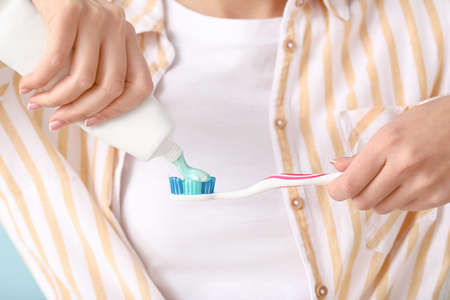 Young woman with toothbrush and paste, closeup