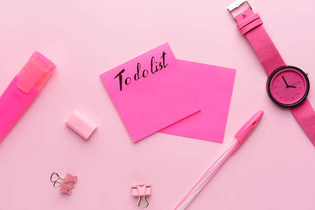 Empty to do list, watch and stationery on color background