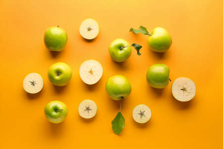 Fresh ripe apples on color backgroundの写真素材