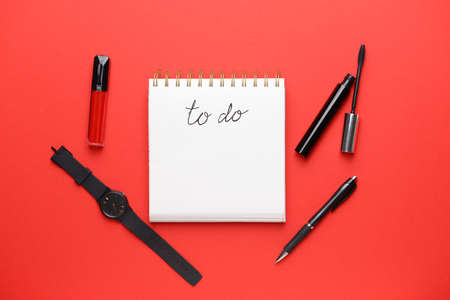 Empty to do list, stationery, mascara and watch on color backgroundの写真素材