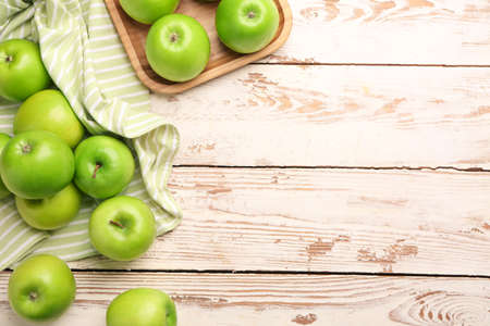 Fresh ripe apples on light wooden backgroundの写真素材