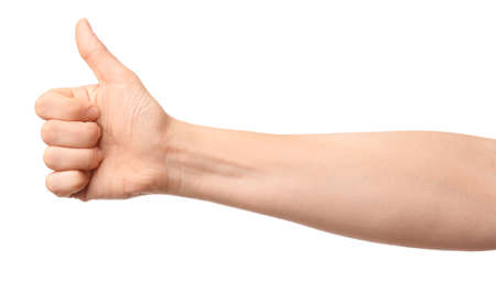 Hand of woman showing thumb-up gesture on white backgroundの写真素材