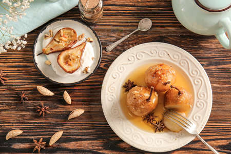 Different sweet cooked pears on wooden tableの写真素材