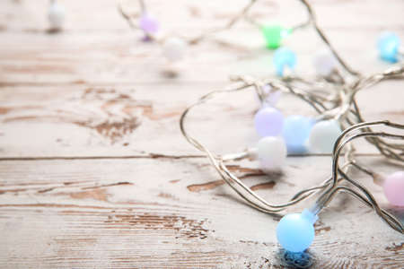 Beautiful Christmas lights on white wooden backgroundの写真素材