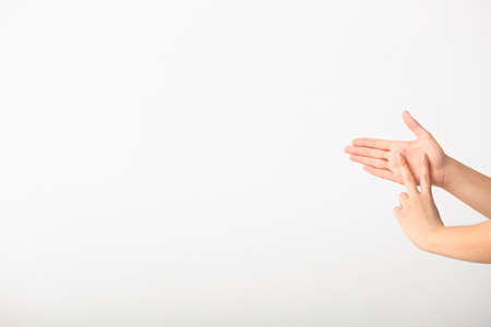 Hands of young deaf mute woman using sign language on white backgroundの写真素材