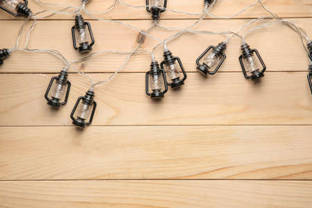 Beautiful Christmas lights on wooden backgroundの写真素材