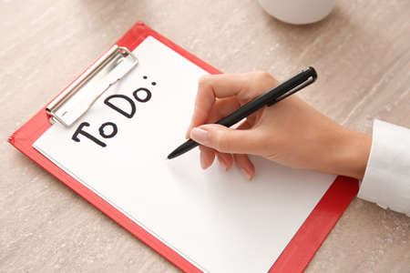 Woman making to-do list at table