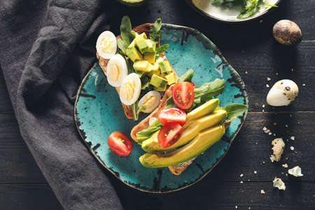 Plate with tasty sandwiches on table