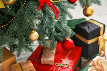 Decorated Christmas tree and gifts, closeup