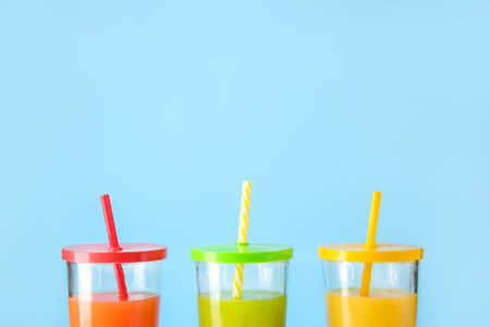Glasses of fresh juice on color backgroundの写真素材