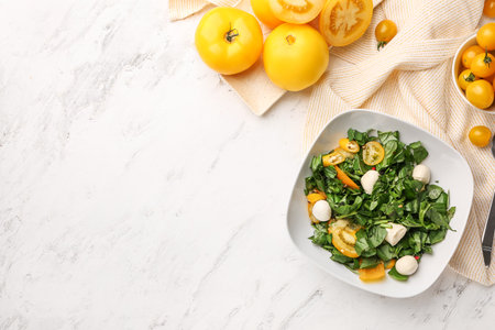 Fresh tomatoes and salad on light backgroundの写真素材