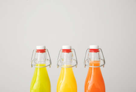 Bottles of fresh juices on gray backgroundの写真素材
