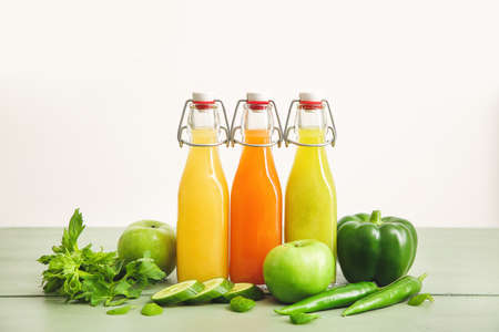 Bottles of fresh juice on tableの写真素材