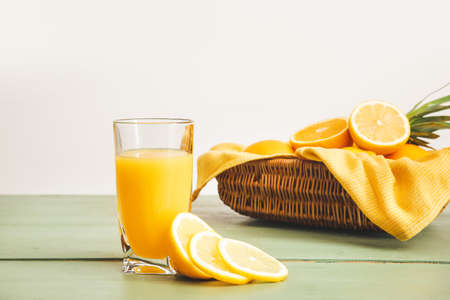 Glass of fresh lemon juice on table