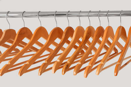Rack with clothes hangers on white background