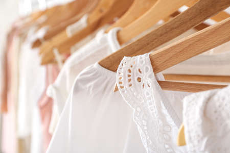 Stylish clothes on hangers in show room, closeupの写真素材