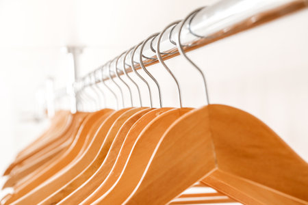 Rack with clothes hangers on white background, closeupの写真素材