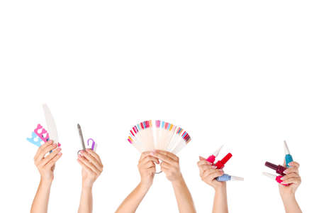 Many hands with supplies for pedicure on white backgroundの写真素材