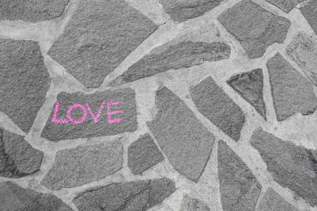 Word LOVE written on stone wallの写真素材