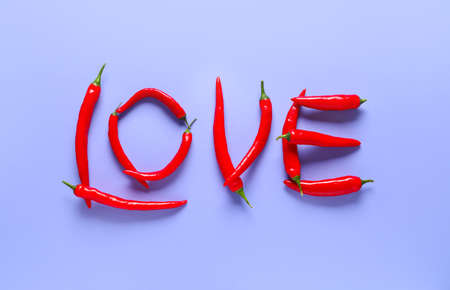 Word LOVE made of chili pepper on color backgroundの写真素材