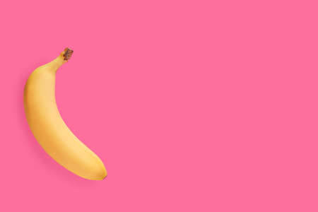 Ripe banana on color backgroundの写真素材