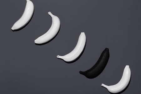 Ripe painted bananas on dark backgroundの写真素材