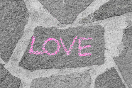 Word LOVE written on stone wallの写真素材