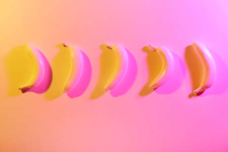 Ripe painted bananas on color backgroundの写真素材