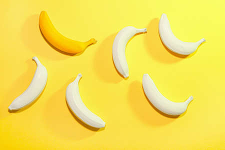 Ripe painted bananas on color backgroundの写真素材