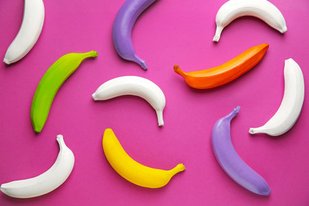 Ripe painted bananas on color backgroundの写真素材