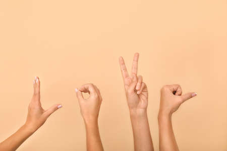 Female hands showing word LOVE on light backgroundの写真素材