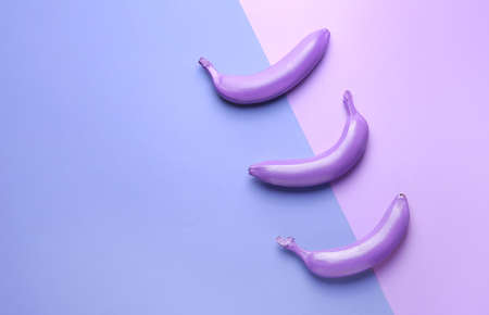 Ripe painted bananas on color backgroundの写真素材