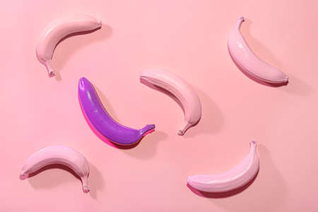 Ripe painted bananas on color backgroundの写真素材