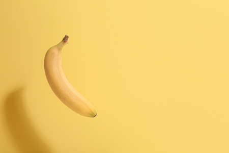 Ripe banana on color backgroundの写真素材