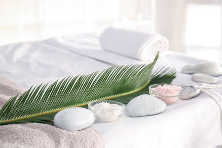 Sea salt with spa stones and tropical leaf in beauty salonの写真素材