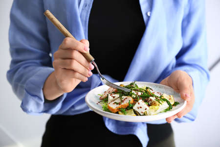 Woman with plate of tasty salad, closeupの写真素材