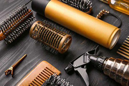 Set of hairdresser tools and accessories on dark wooden backgroundの写真素材