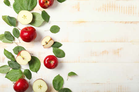 Fresh ripe apples on white wooden backgroundの写真素材