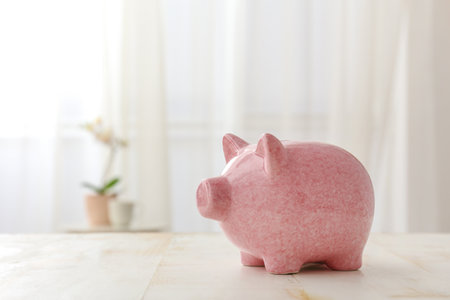 Piggy bank on table in roomの写真素材