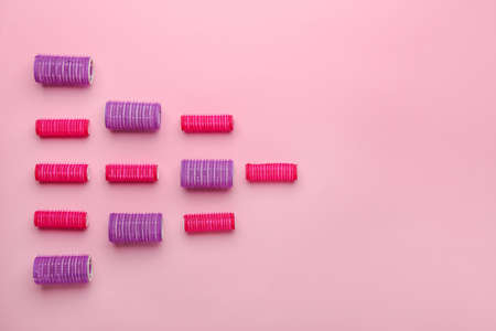Set of hair curlers on color backgroundの写真素材