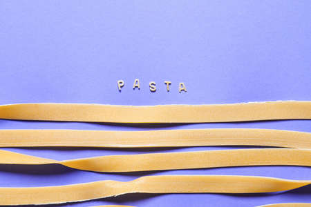 Composition with dry pasta on color backgroundの写真素材
