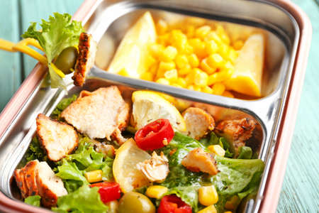 Lunch box with tasty chicken salad on table, closeupの写真素材
