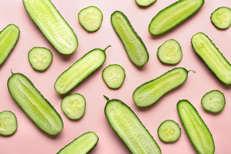 Pieces of fresh cucumbers on color backgroundの写真素材